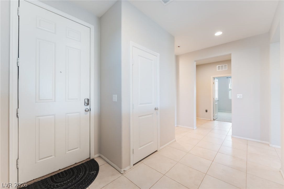 Tiled flooring and recessed lighting define this welcoming entry hallway.