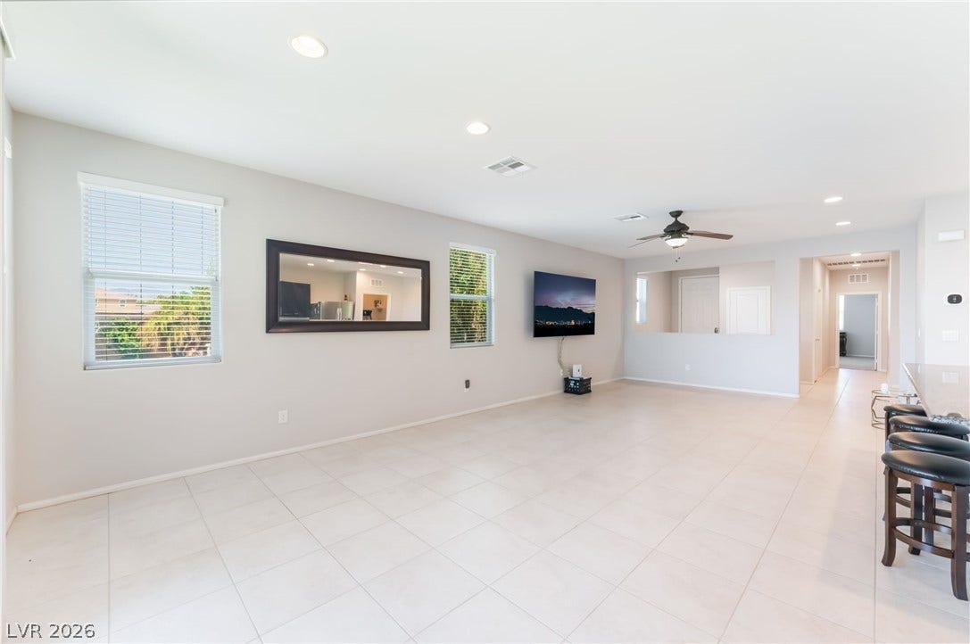 Gleaming tile floors and recessed lighting enhance the open flow of this versatile living space.