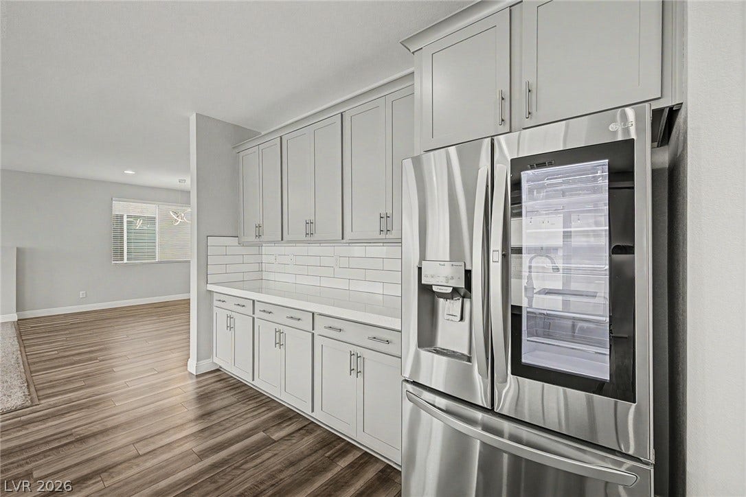 4618 Summer Azure Street, North Las Vegas, NV 89031 Gleaming stone countertops and matching cabinetry elevate this modern culinary space.