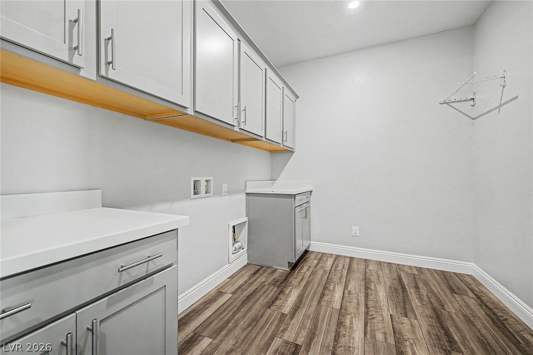 4618 Summer Azure Street, North Las Vegas, NV 89031 Ample cabinetry and stone countertops elevate this highly functional utility space.