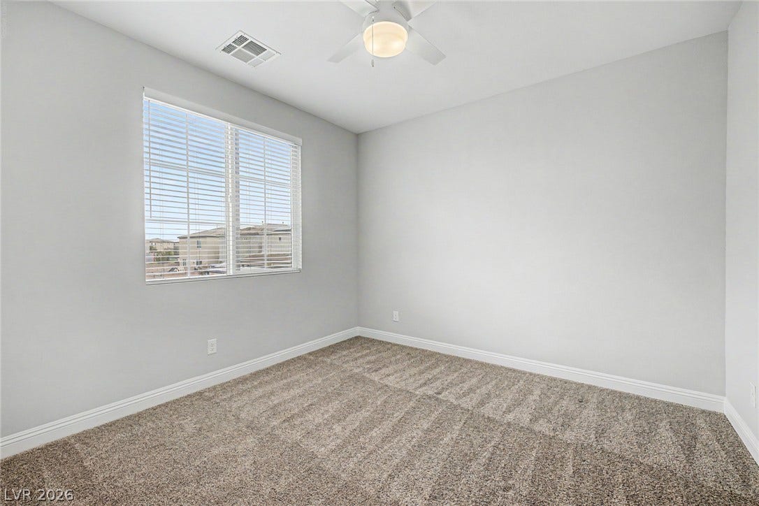 4618 Summer Azure Street, North Las Vegas, NV 89031 Plush carpeting and a large window create a comfortable and inviting atmosphere.