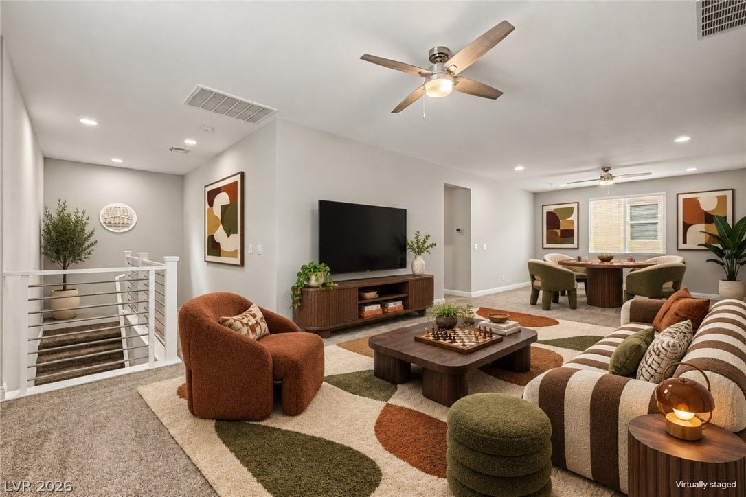 4618 Summer Azure Street, North Las Vegas, NV 89031 A spacious layout connects the upper-level living areas with clean lines and classic carpeting.