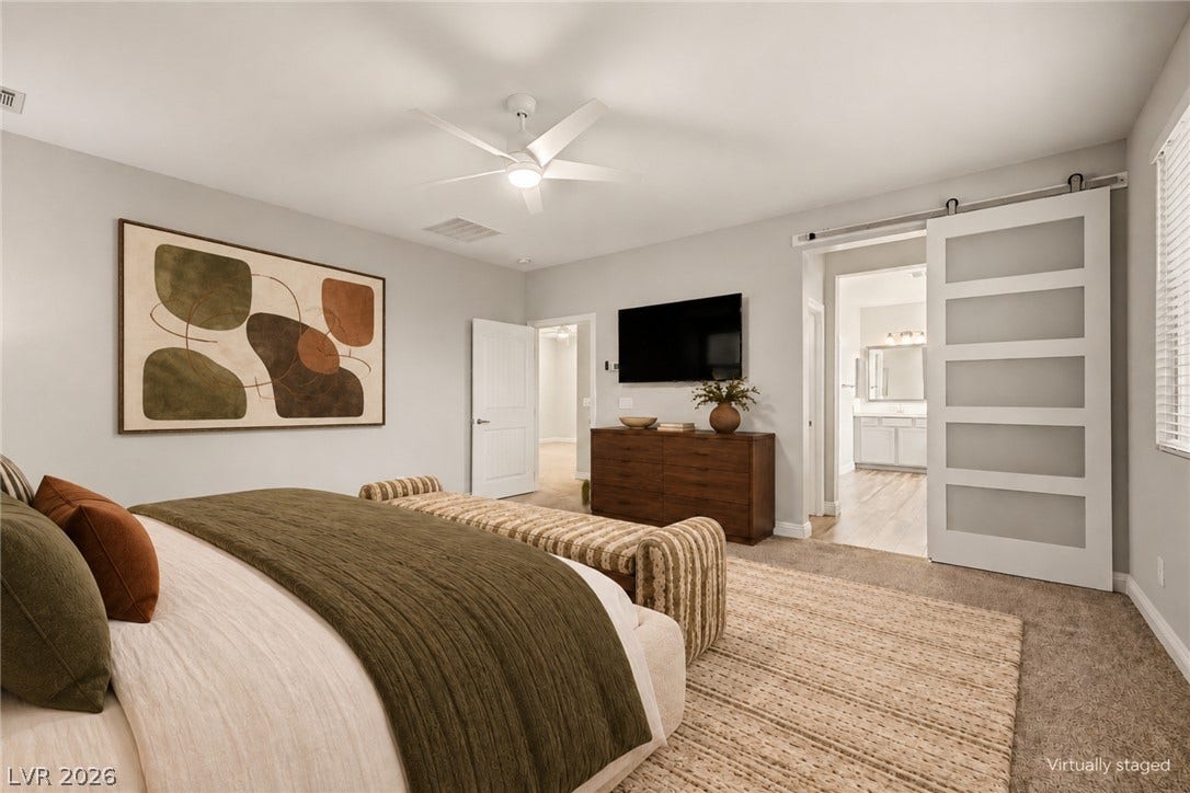 4618 Summer Azure Street, North Las Vegas, NV 89031 An open sliding barn door connects this spacious bedroom directly to the adjacent bathroom.