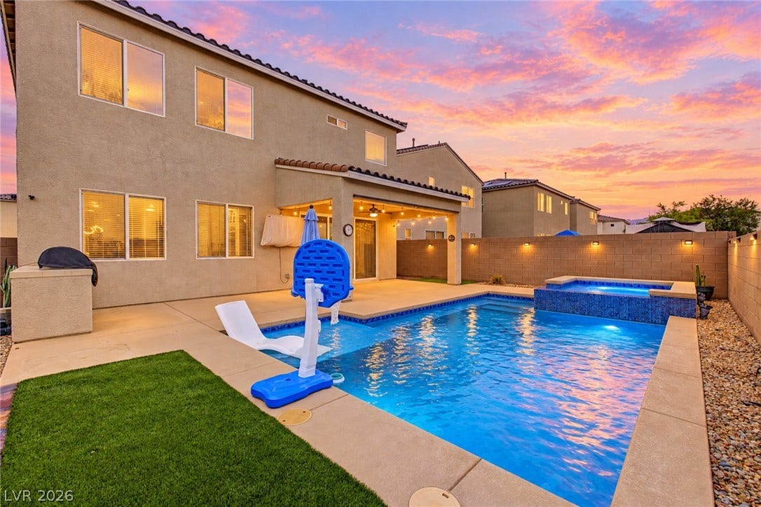4618 Summer Azure Street, North Las Vegas, NV 89031 An inviting backyard oasis features a shimmering swimming pool paired with a custom spa.