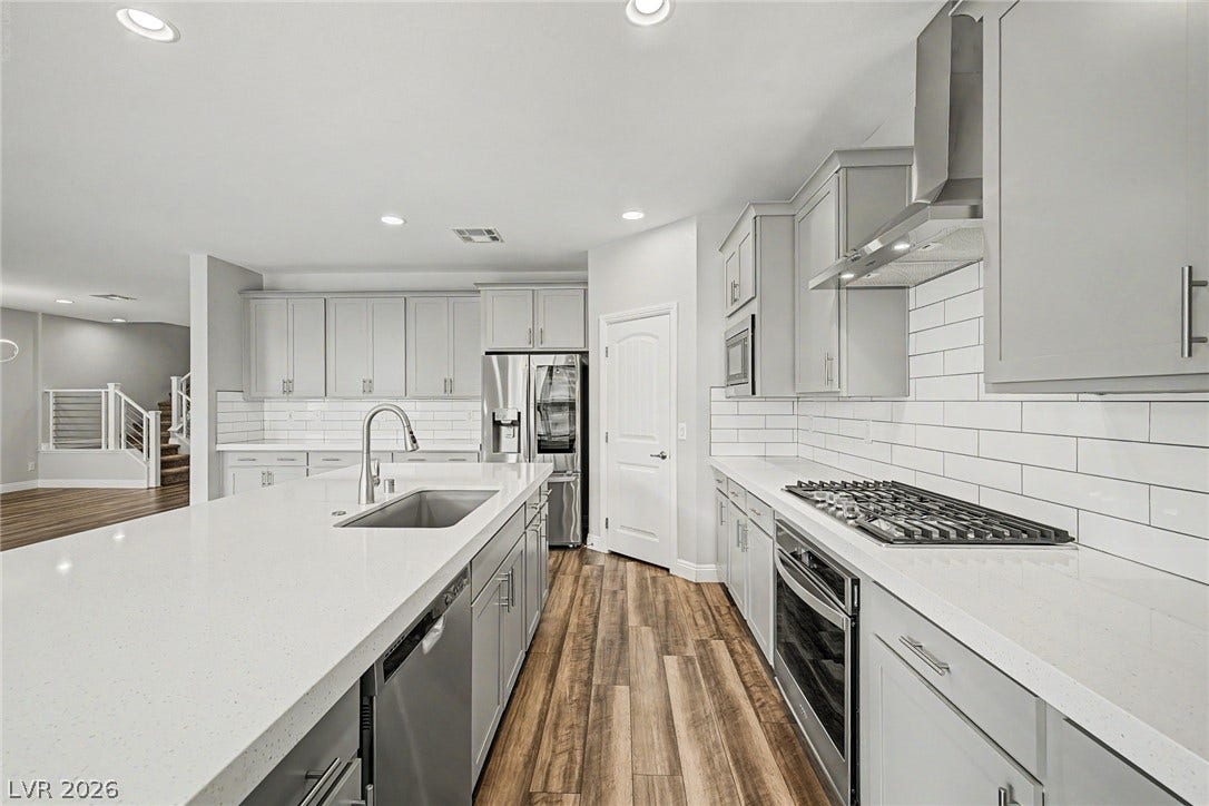 4618 Summer Azure Street, North Las Vegas, NV 89031 Polished stone countertops and seamless cabinetry frame this functional modern workspace.