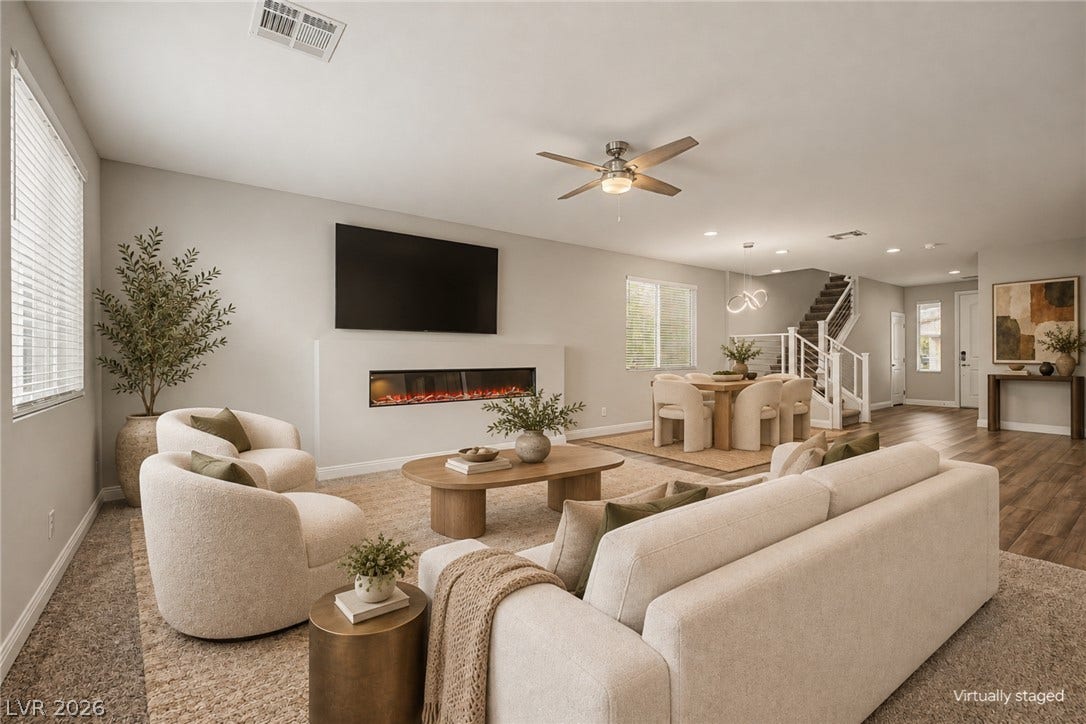 4618 Summer Azure Street, North Las Vegas, NV 89031 An integrated linear fireplace anchors this modern open space with warm wood-style flooring.