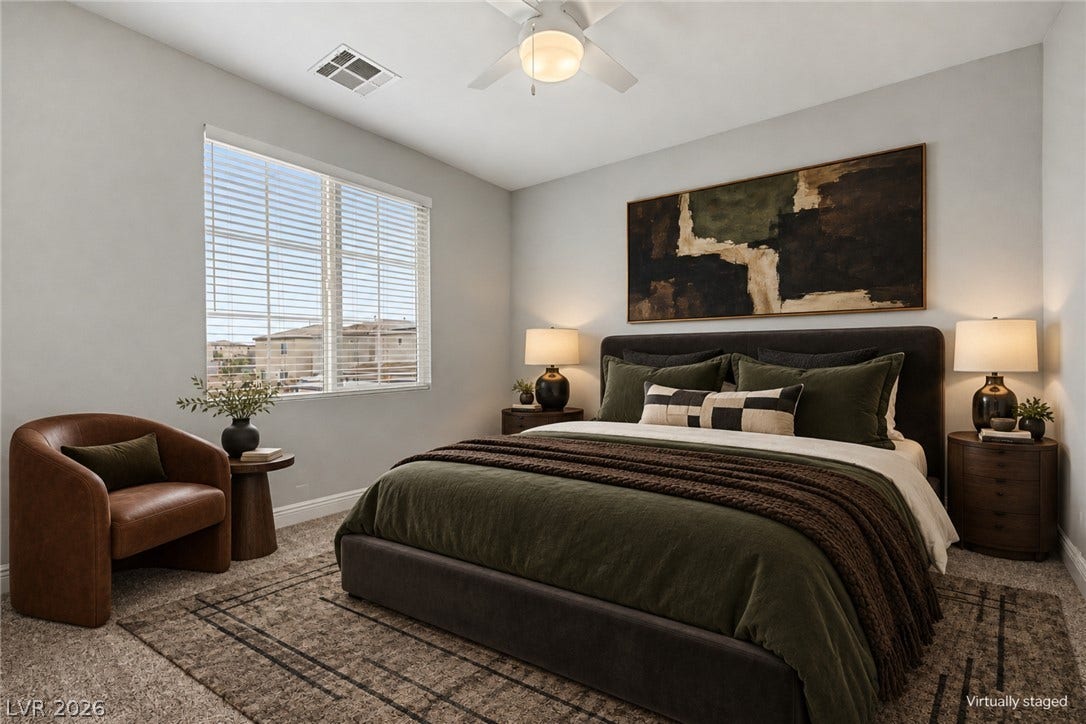4618 Summer Azure Street, North Las Vegas, NV 89031 A spacious window welcomes abundant natural light into this cozy bedroom featuring soft plush carpeting.