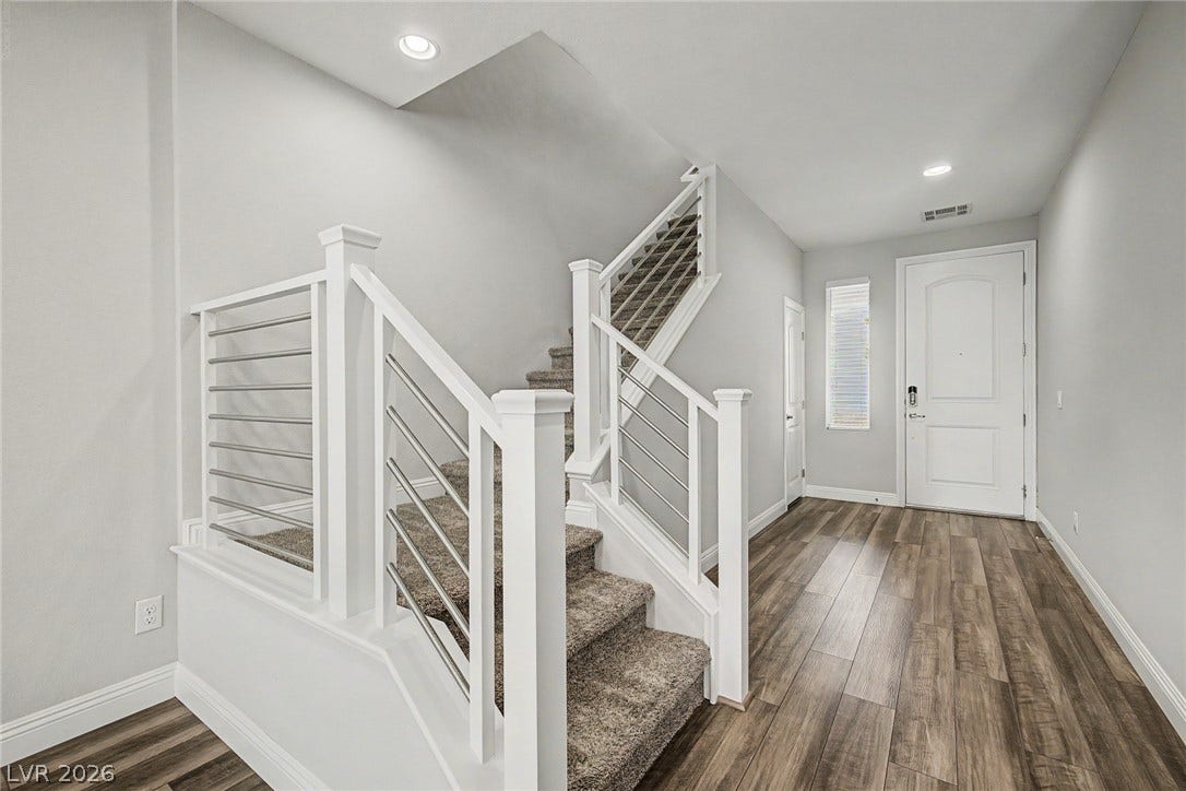 4618 Summer Azure Street, North Las Vegas, NV 89031 An inviting entryway transitions smoothly into a modern staircase with clean architectural lines.