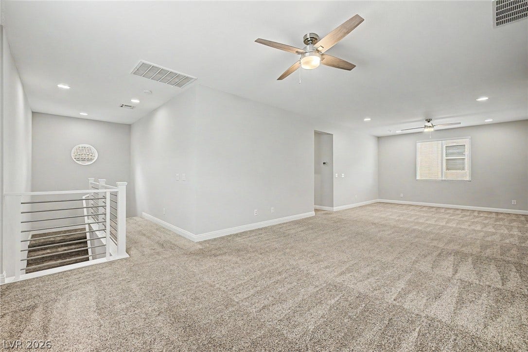 4618 Summer Azure Street, North Las Vegas, NV 89031 An open upstairs landing features comfortable carpeting, recessed lighting, and a modern stair railing.