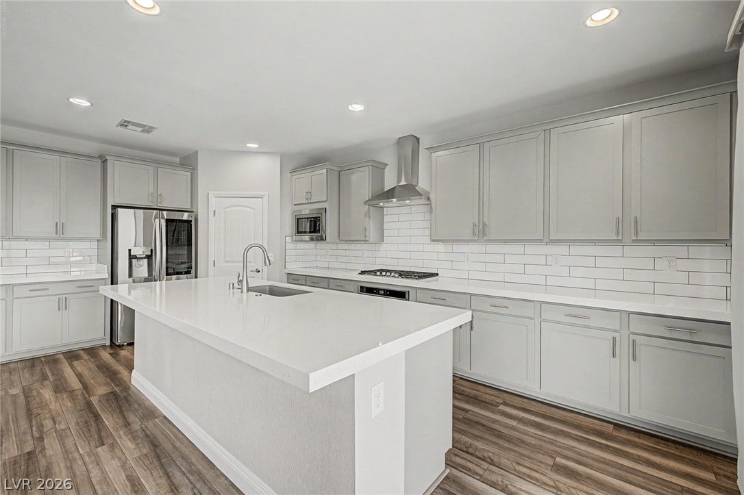 4618 Summer Azure Street, North Las Vegas, NV 89031 Gleaming stone countertops and a spacious central island anchor this contemporary cooking space.