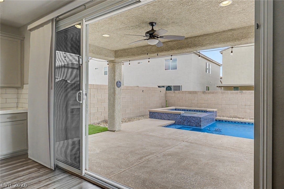 4618 Summer Azure Street, North Las Vegas, NV 89031 Sliding glass doors open directly to a covered patio and a private swimming pool.
