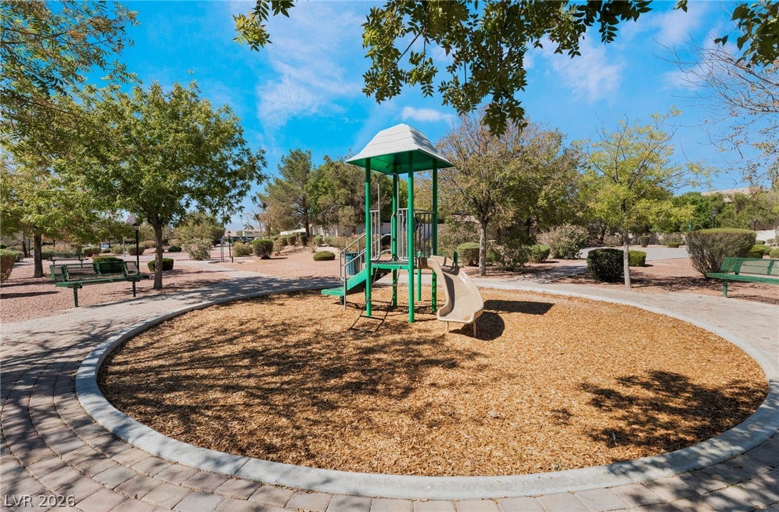 6527 Velvet Silk Street, North Las Vegas, NV 89084 Mature trees shade a circular playground area encircled by paved walkways and benches.