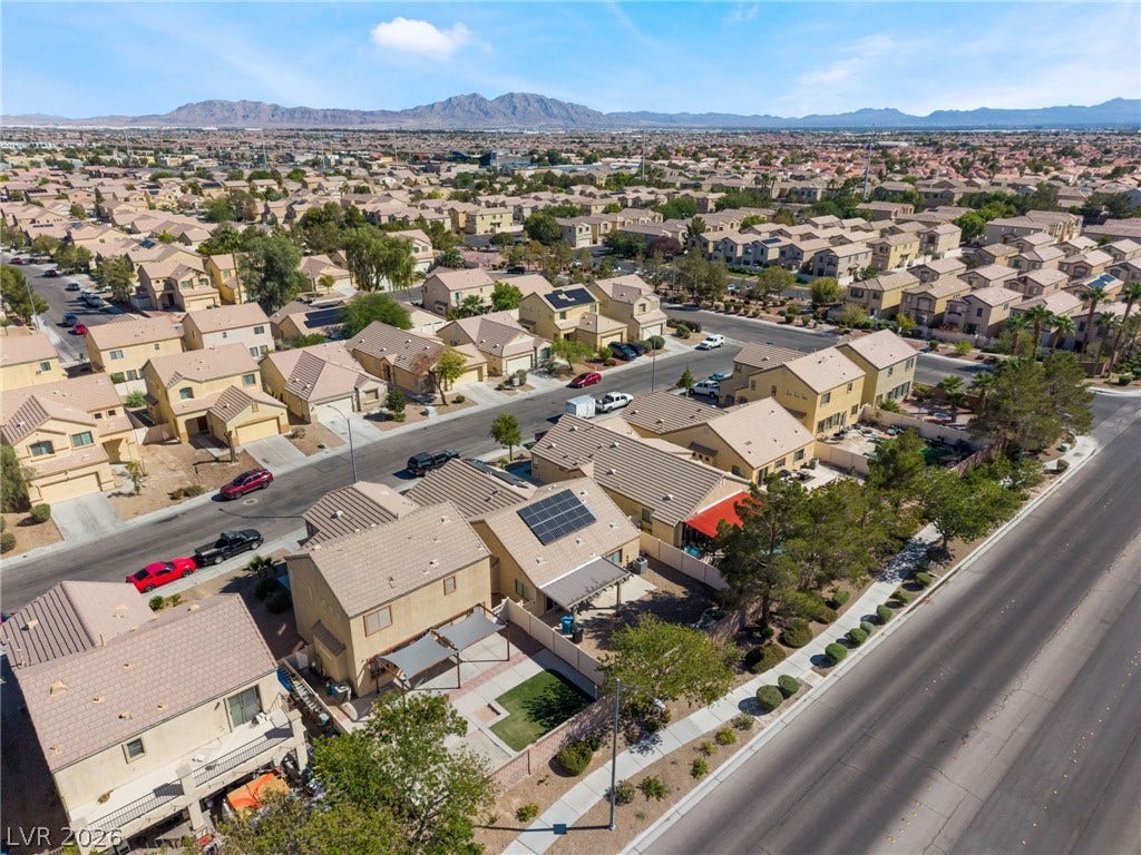 6527 Velvet Silk Street, North Las Vegas, NV 89084 An aerial perspective showcases a neat residential neighborhood framed by majestic distant mountains.