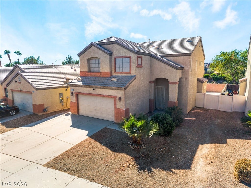 6527 Velvet Silk Street, North Las Vegas, NV 89084 A classic stucco exterior features a tile roof and a spacious concrete driveway.