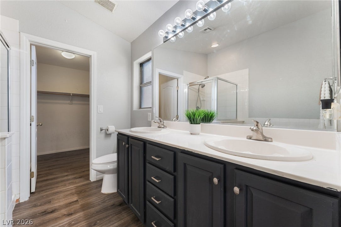 6527 Velvet Silk Street, North Las Vegas, NV 89084 Clean lines and a spacious dual vanity define this functional primary bathroom.