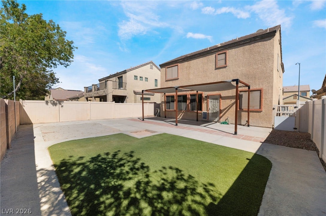 6527 Velvet Silk Street, North Las Vegas, NV 89084 An inviting backyard features low-maintenance synthetic turf and a spacious covered patio.