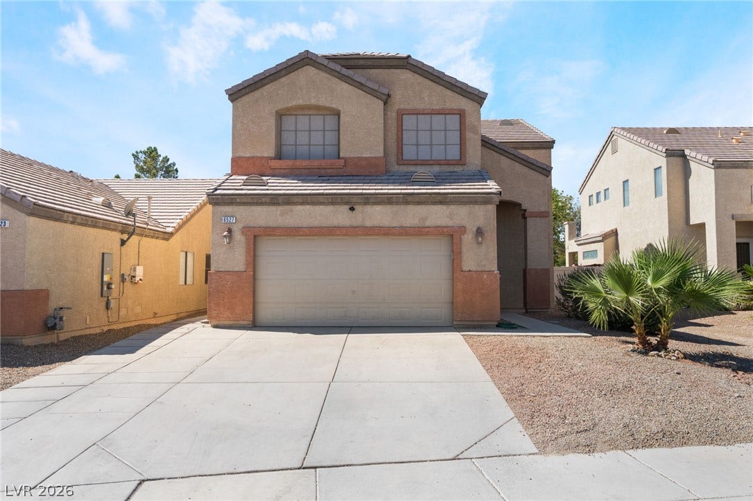 6527 Velvet Silk Street, North Las Vegas, NV 89084 A classic two-story stucco exterior features a concrete driveway and tile roof.