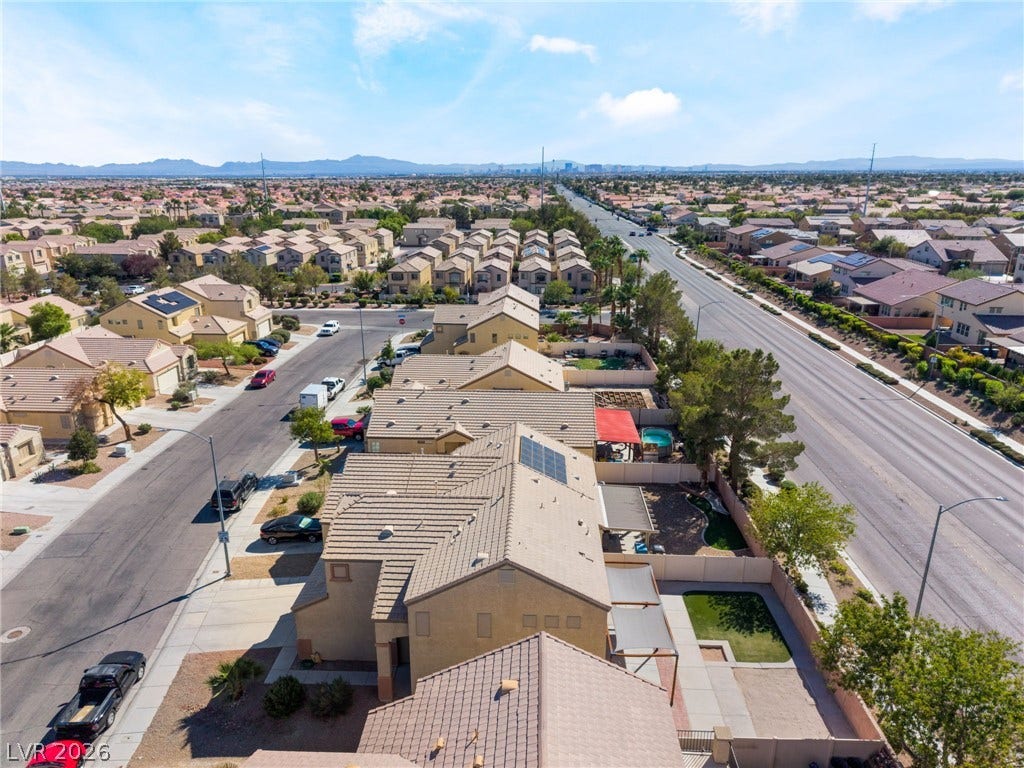6527 Velvet Silk Street, North Las Vegas, NV 89084 Sun-drenched neighborhood streets offer distant mountain views under a bright desert sky.