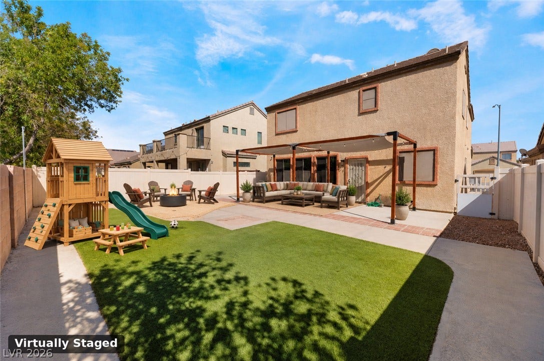 6527 Velvet Silk Street, North Las Vegas, NV 89084 Virtually staged - A spacious backyard features concrete and paved walkways, an artificial turf lawn, and a sand pit area to easily host a fire pit area.