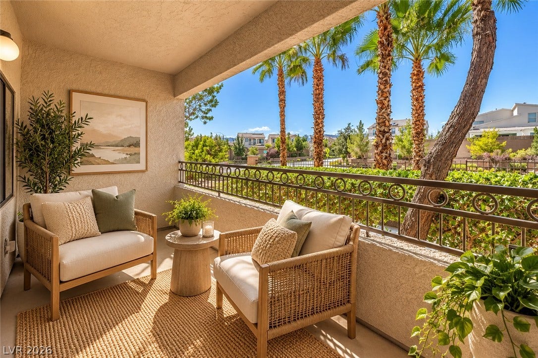 8250 N Grand Canyon Drive, #1006, Las Vegas, NV 89166 Digitally Staged* A covered private balcony looks out over manicured neighborhood landscaping and towering palm trees.