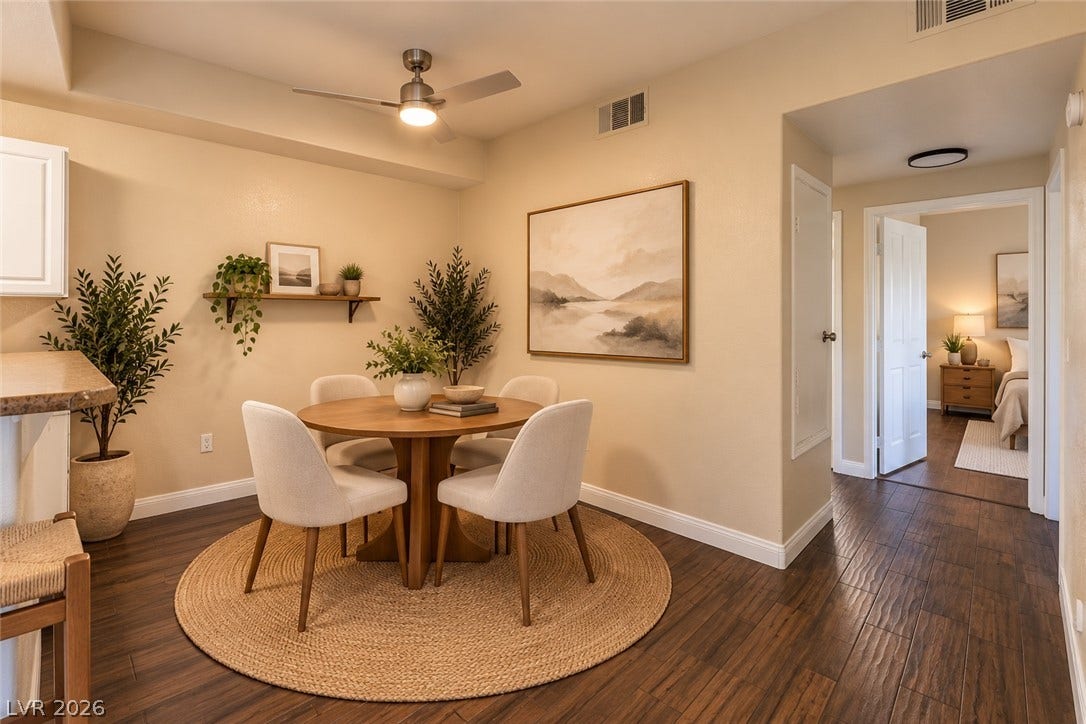 8250 N Grand Canyon Drive, #1006, Las Vegas, NV 89166 Digitally Staged* Rich wood flooring grounds this cozy dining space, offering seamless transition to the hallway.