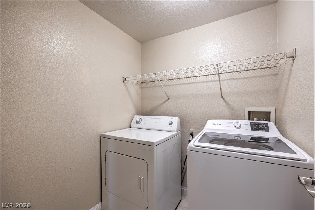 8250 N Grand Canyon Drive, #1006, Las Vegas, NV 89166 A dedicated laundry space features structured shelving and room for side-by-side appliances.