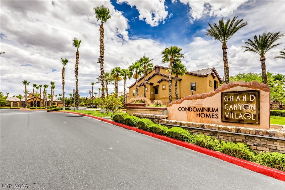 8250 N Grand Canyon Drive, #1006, Las Vegas, NV 89166 Palm trees frame the stone monument entrance to this welcoming residential community.