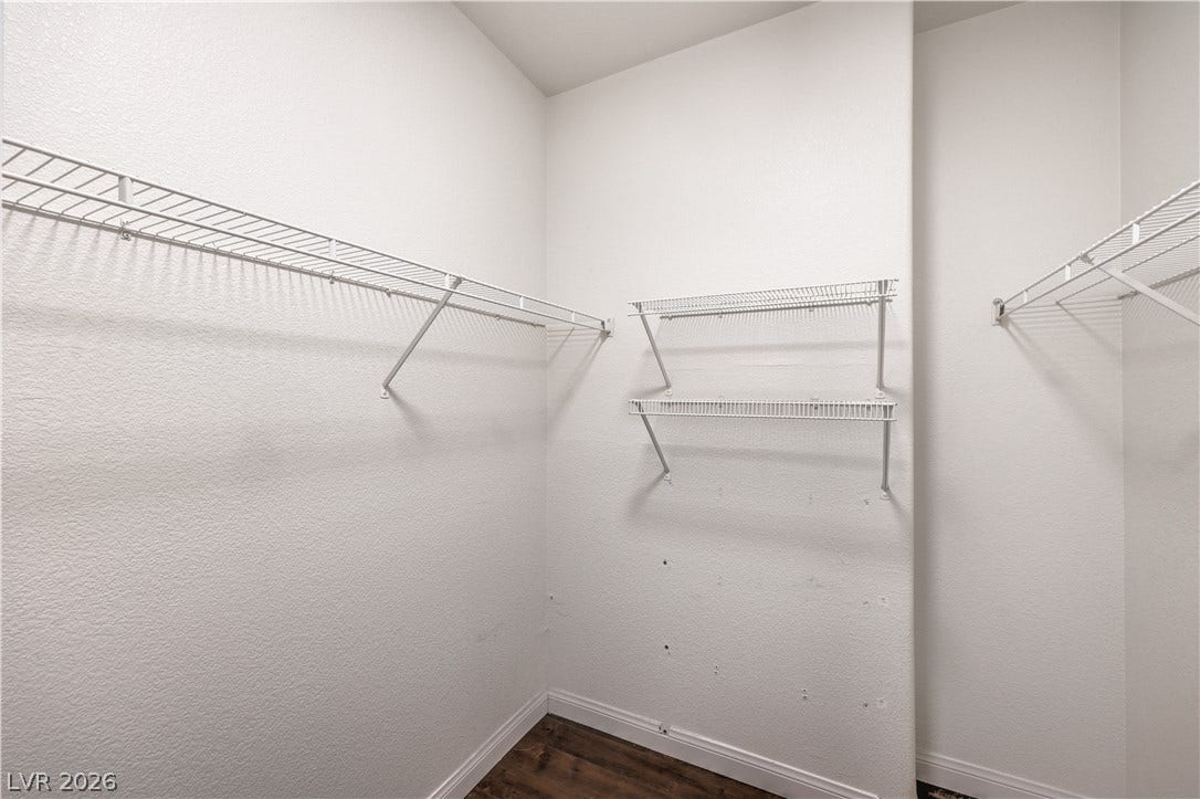8250 N Grand Canyon Drive, #1006, Las Vegas, NV 89166 Ample wire shelving lines this functional walk-in closet featuring warm wood flooring.