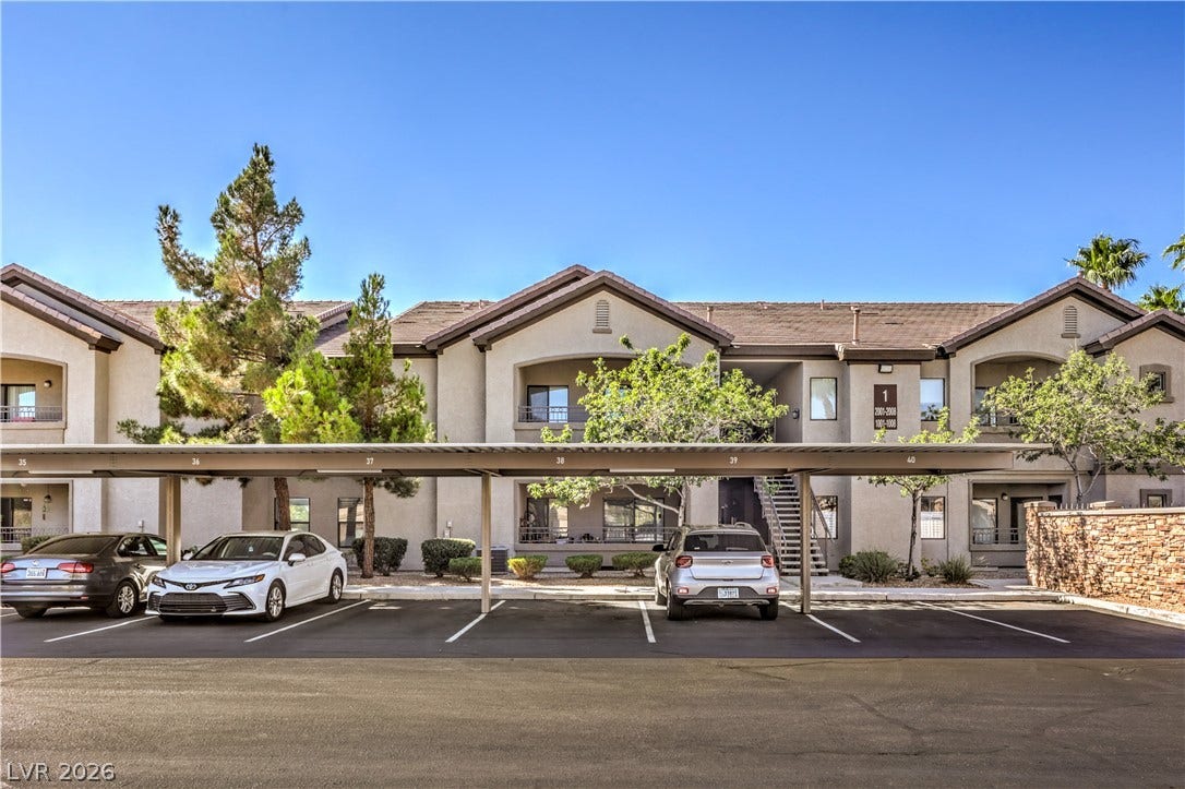 8250 N Grand Canyon Drive, #1006, Las Vegas, NV 89166 Multi-level residential building showcases tile roofing and structured stucco exteriors.