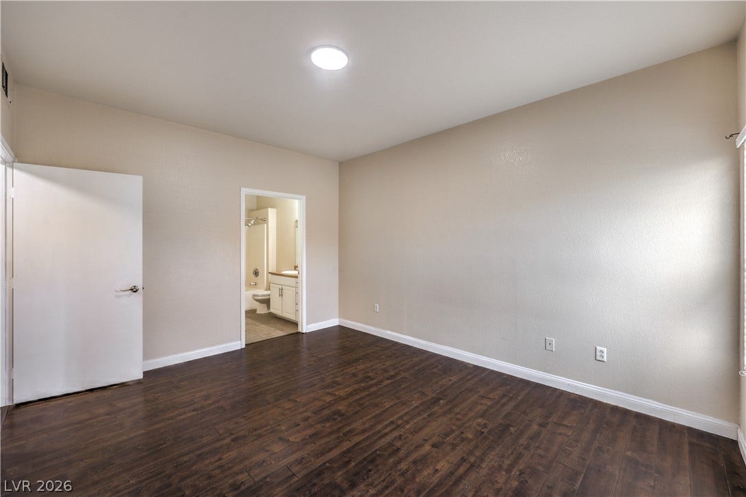 8250 N Grand Canyon Drive, #1006, Las Vegas, NV 89166 Rich wood-look flooring and smooth plaster walls define this versatile bedroom suite.