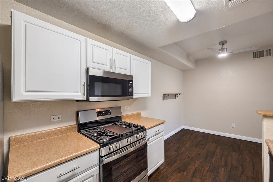 8250 N Grand Canyon Drive, #1006, Las Vegas, NV 89166 Rich wood-inspired floors anchor this functional cooking space complete with clean cabinetry.