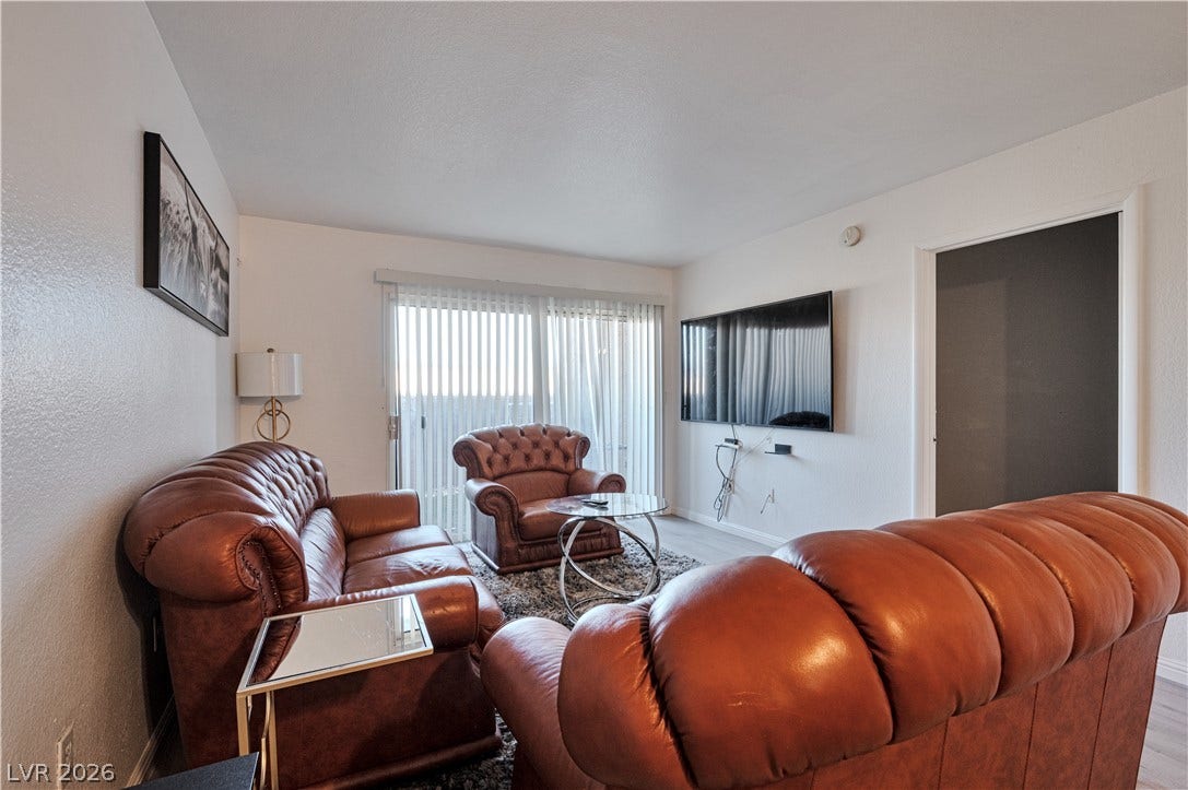 Sliding glass doors open from the living area to invite plenty of natural light.