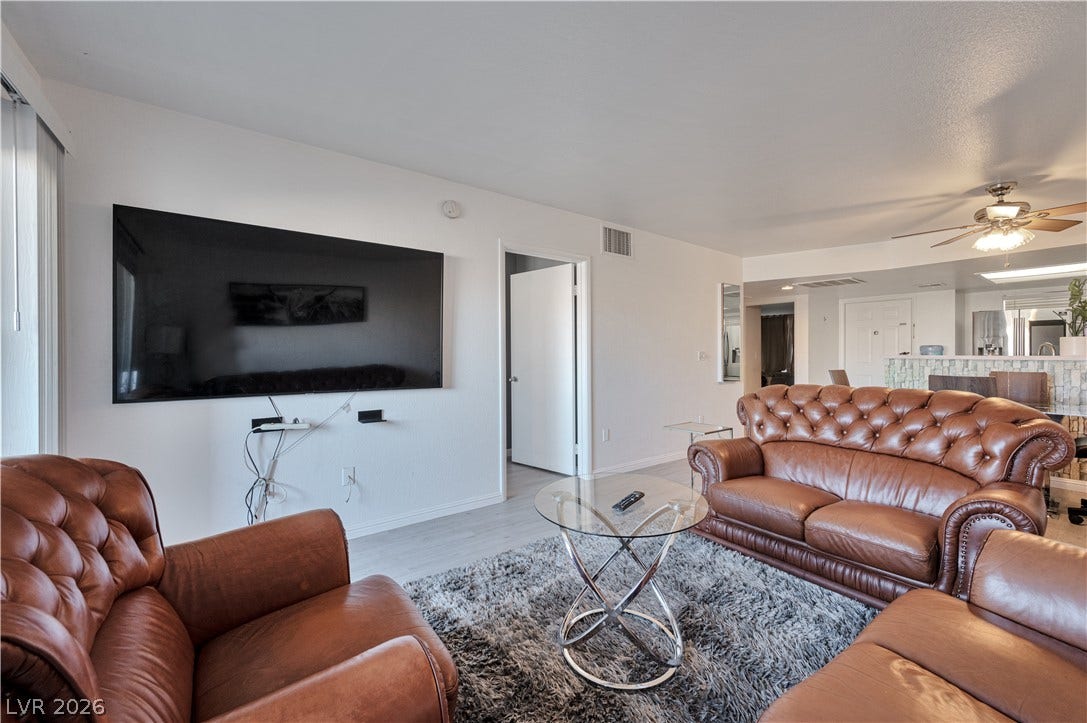 An open layout connects the living area seamlessly to the nearby kitchen.