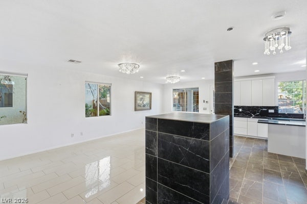 9726 Sweet Jasmine Drive, Las Vegas, NV 89148 Gleaming tile floors and custom stone pillars define this airy, open-concept interior layout.