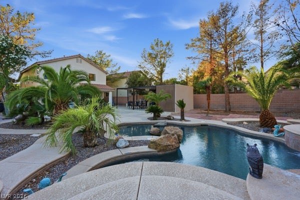 9726 Sweet Jasmine Drive, Las Vegas, NV 89148 Lush palm trees frame a sparkling freeform pool in this private backyard oasis.
