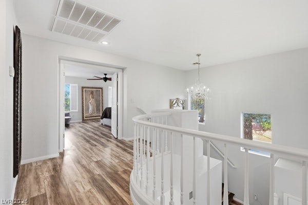 9726 Sweet Jasmine Drive, Las Vegas, NV 89148 Rich wood-inspired floors flow past a curved staircase landing into an inviting upper level.