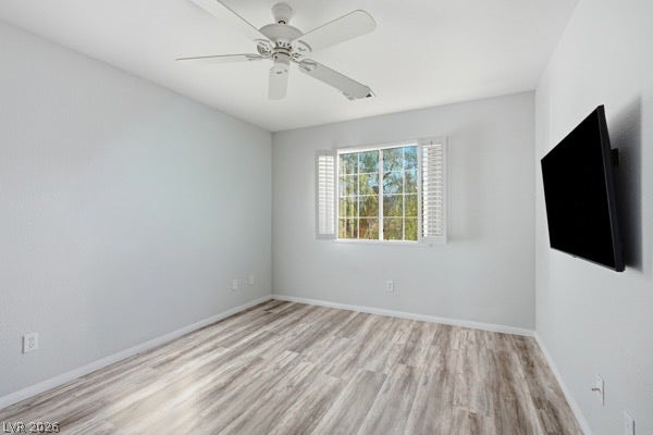 9726 Sweet Jasmine Drive, Las Vegas, NV 89148 Smooth wood-look flooring and a plantation-shuttered window highlight this clean, versatile bedroom space.