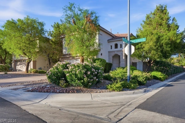 9726 Sweet Jasmine Drive, Las Vegas, NV 89148 Mature trees and neat desert landscaping surround this two-story corner lot home.