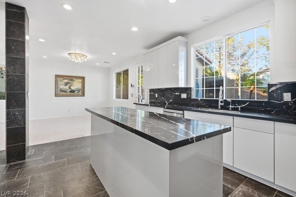 9726 Sweet Jasmine Drive, Las Vegas, NV 89148 Polished stone surfaces contrast beautifully with minimalist cabinetry in this light-filled modern kitchen.