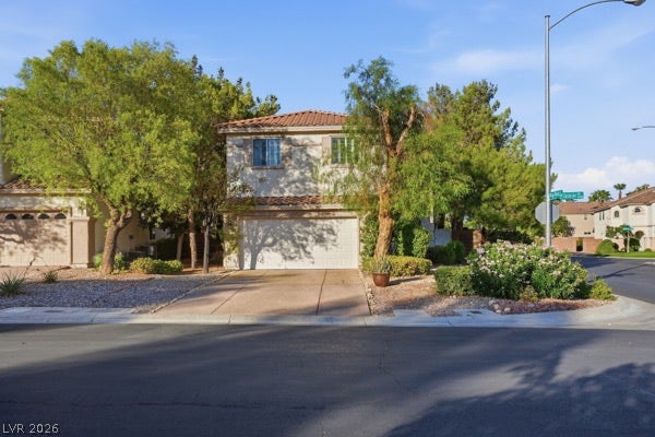 9726 Sweet Jasmine Drive, Las Vegas, NV 89148 Mature trees frame the classic stucco exterior and tiled roof of this two-story corner residence.