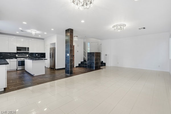 9726 Sweet Jasmine Drive, Las Vegas, NV 89148 Polished tile flooring and architectural pillars define this seamlessly integrated, open-concept living space.