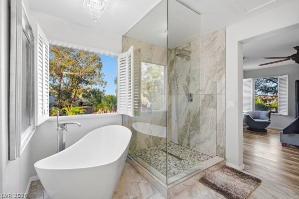 9726 Sweet Jasmine Drive, Las Vegas, NV 89148 Large window openings fill this bathroom with light next to a glass-enclosed walk-in shower.