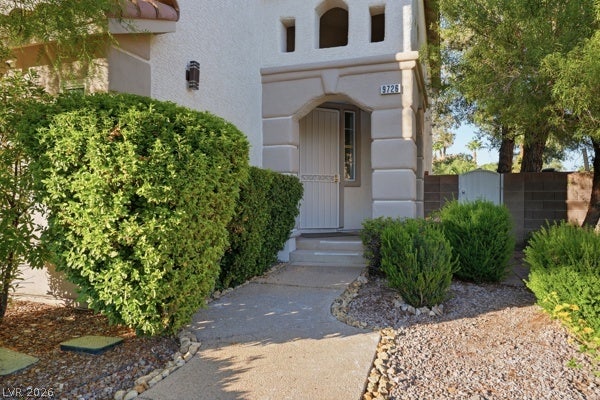 9726 Sweet Jasmine Drive, Las Vegas, NV 89148 An inviting concrete walkway leads directly to the covered stucco entryway of this home.