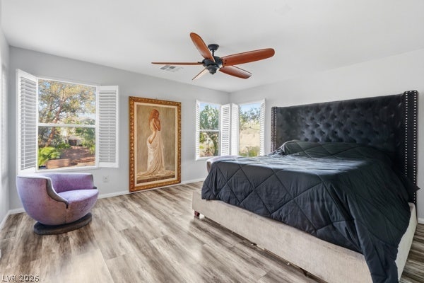 9726 Sweet Jasmine Drive, Las Vegas, NV 89148 Generous windows frame neighborhood views, illuminating the polished wood-look floors in this quiet retreat.