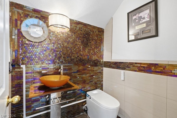 9726 Sweet Jasmine Drive, Las Vegas, NV 89148 Glimmering mosaic wall tiles and a glass vessel sink define this contemporary powder room.