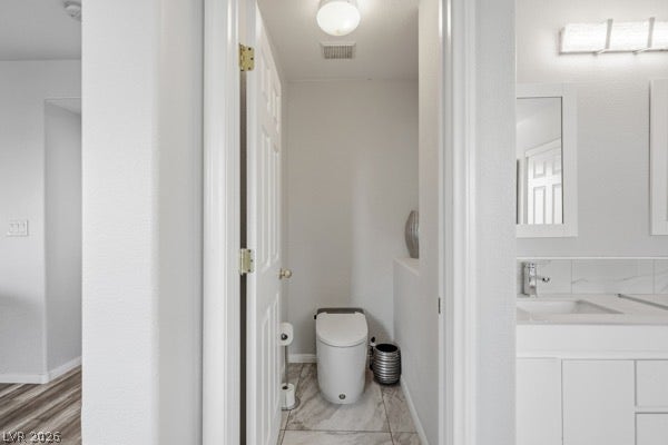 9726 Sweet Jasmine Drive, Las Vegas, NV 89148 Clean lines and tiled flooring define this modern bathroom layout with dual vanity area.