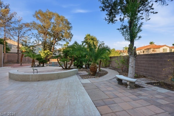 9726 Sweet Jasmine Drive, Las Vegas, NV 89148 Lush palm trees and paved walkways create a tranquil setting in this private yard.