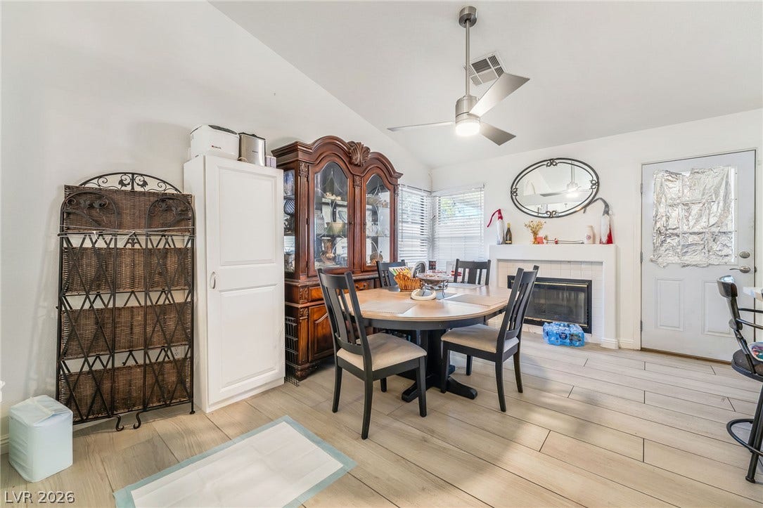 125 Heather Drive, Henderson, NV 89002 An inviting dining room features a cozy fireplace and clean tile flooring.