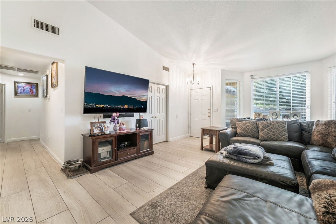 125 Heather Drive, Henderson, NV 89002 Vaulted ceilings and wood-look tile flooring create a spacious, inviting main living area.