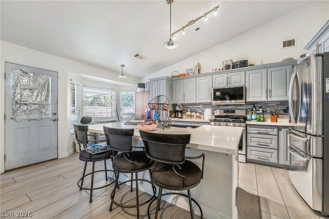 125 Heather Drive, Henderson, NV 89002 An expansive kitchen island anchors this cooking space finished with wood-look tile floors.